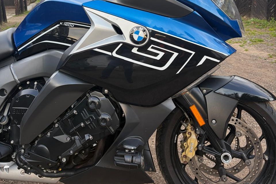 Close-up of the GT livery, BMW roundel and six-cylinder engine on a blue BMW K1600 GT.