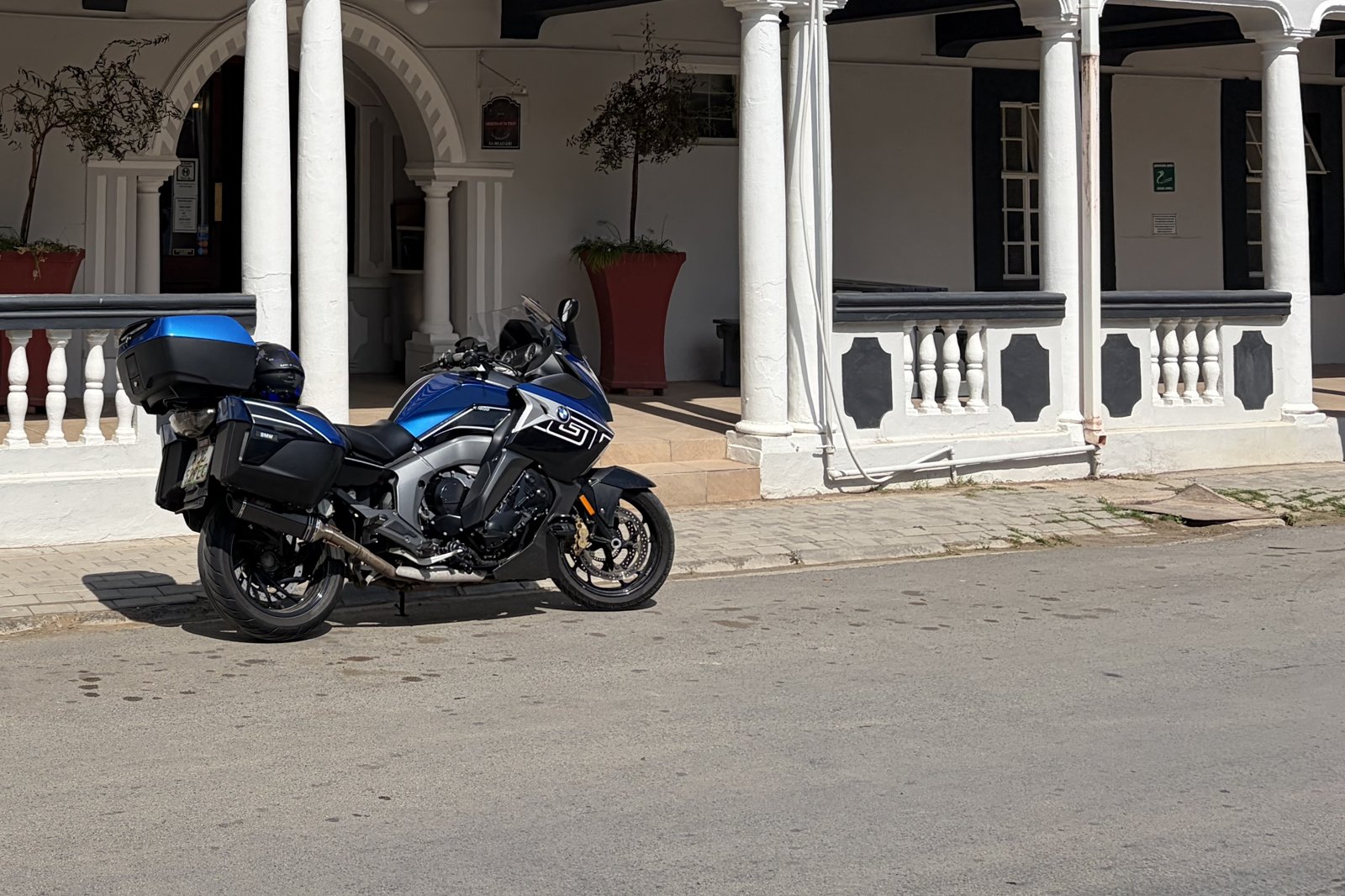 A BMW K1600 GT parked outside a Cape Dutch heritage hotel in a small Karoo town.
