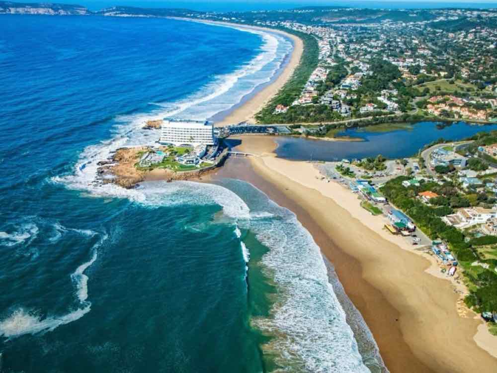 Aerial view of Plettenberg Bay — beach, lagoon and headland hotel.